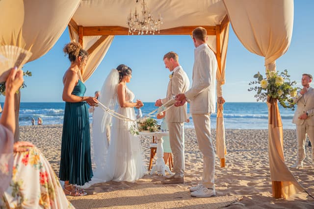 Destination wedding ceremony on a beach overlooking the ocean
