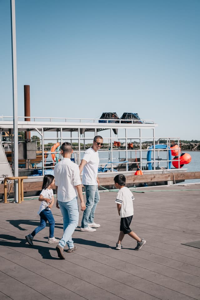 Family exploring together along a waterfront