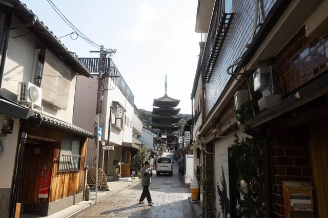 Historic street in Kyoto leading toward a pagoda